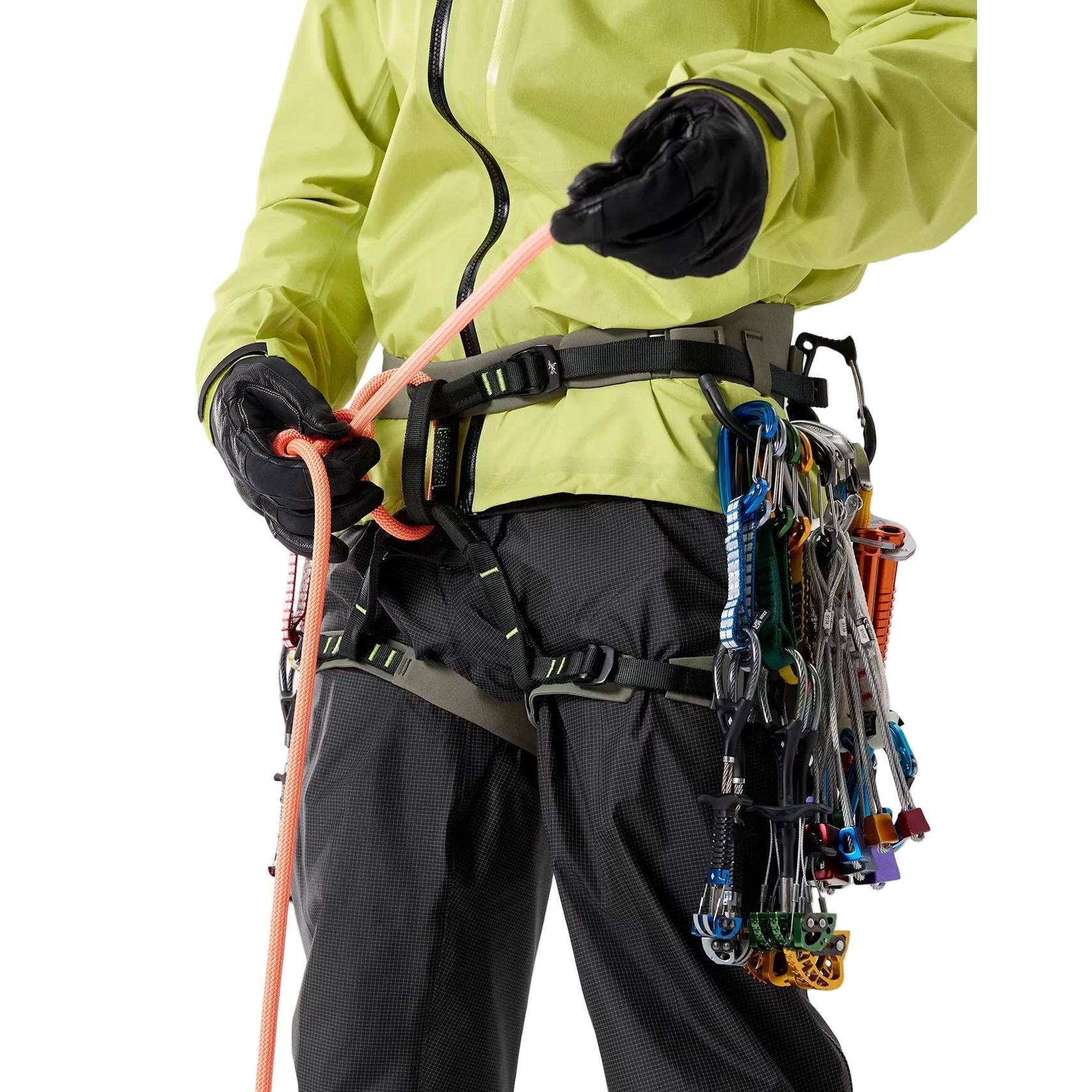 Person wearing Arcteryx AR-395a climbing harness with ropes and equipment on a plain background