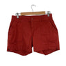 PRANA Women's ELLE 5" inseam shorts in terracotta red with front button and cargo pockets.