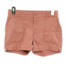 PRANA Women's ELLE 5" inseam shorts in terracotta, featuring front patch pockets and button closure.